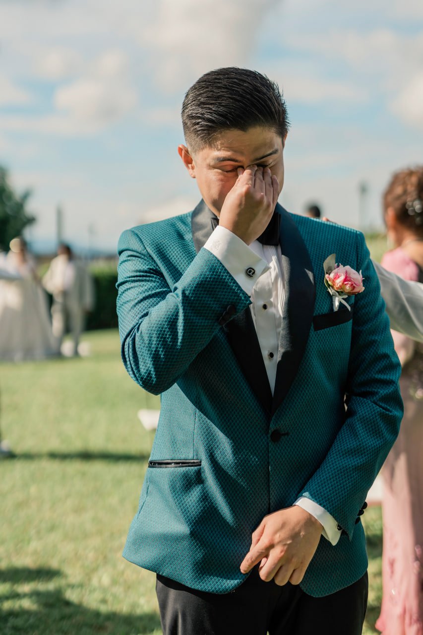 groom crying at the entrance of the bride